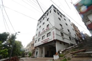 ナスドワーラにあるHotel shree Dhwaja Inn - 100 meter from shreenathji Templeの街の通りにある大きな白い建物