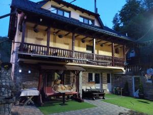 a large house with a balcony on the side of it at Casa Coltea in Moieciu de Jos