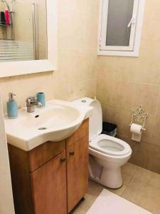 荷兹利亚BHerzliya Pituach Beach Studio的带白色水槽和马桶的浴室