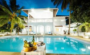 a villa with a swimming pool and a house at Casa Zuri Diani Beach Villa in Diani Beach
