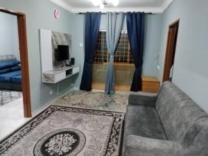 a living room with a couch and a television at Amara Homestay Cameron Highlands in Cameron Highlands