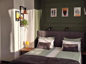 a bedroom with a bed with two pillows at Студио Даневски-Balkan Tower in Gabrovo