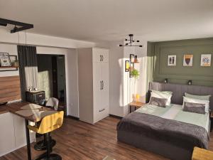 a bedroom with a bed and a desk in it at Студио Даневски-Balkan Tower in Gabrovo