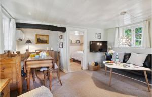 a living room with a bed and a table at 3 Bedroom Gorgeous Home In Nexø in Neksø