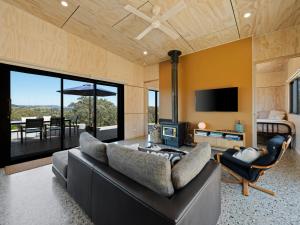 a living room with a couch and a television at The Hill House in Mansfield