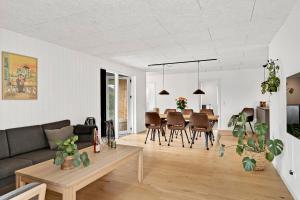 a living room with a couch and a table at Beautiful Holiday Home For 2 Families Near Grenaa Beach in Grenå