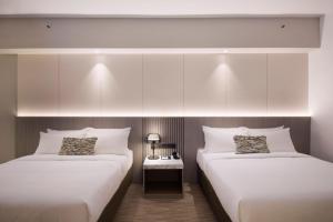 Postel nebo postele na pokoji v ubytování RELC International Hotel