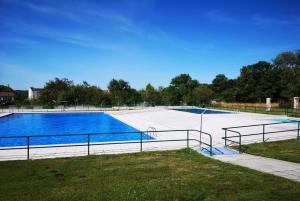 a large empty swimming pool in a park at Casa Lamela in Villasante