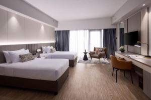 Postel nebo postele na pokoji v ubytování RELC International Hotel