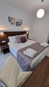 A bed or beds in a room at International Atene hotel