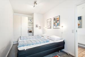 a bedroom with two beds and a mirror at Beautiful Ground-Floor Holiday Apartment With A Sea View in Ebeltoft