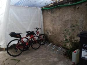 a red bike is parked in a garage at L'Appart' Abri vélos - Bikes shelter in Châtellerault