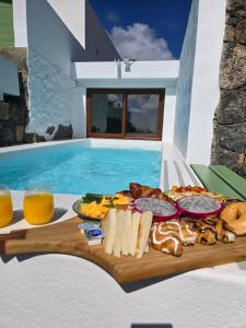a tray of food next to a swimming pool at La Cabaña Del Sol in La Asomada
