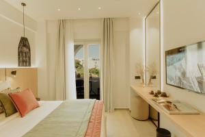 a bedroom with a bed and a sink in it at Opal Paros in Naousa