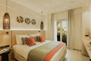 a bedroom with a large bed with pillows at Opal Paros in Naousa