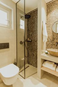 a bathroom with a shower and a toilet and a sink at Opal Paros in Naousa