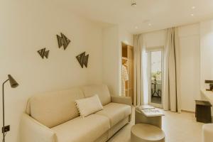 a living room with a couch and a table at Opal Paros in Naousa