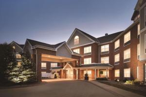 a large brick building with a driveway in front at Country Inn & Suites by Radisson, Des Moines West, IA in Clive