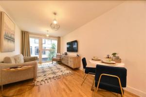 a living room with a couch and a table at Mulberry House in Stevenage