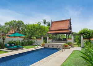 a pool with a gazebo next to a house at Banyan Tree Phuket in Bang Tao Beach