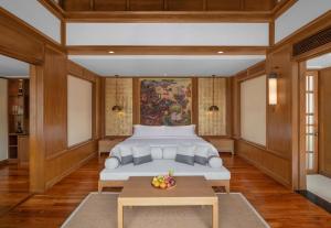 a bedroom with a bed and a table at Banyan Tree Phuket in Bang Tao Beach