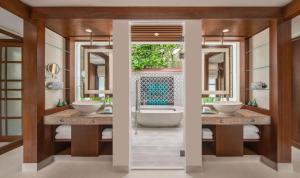 a bathroom with two sinks and a bath tub at Banyan Tree Phuket in Bang Tao Beach