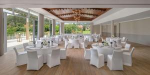 a banquet hall with white tables and white chairs at Banyan Tree Phuket in Bang Tao Beach