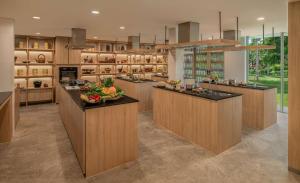 a large kitchen with wooden cabinets and a counter top at Banyan Tree Phuket in Bang Tao Beach