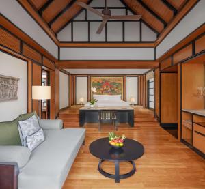a living room with a couch and a table at Banyan Tree Phuket in Bang Tao Beach
