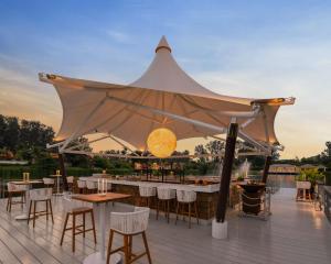 a tent on a deck with tables and chairs at Banyan Tree Phuket in Bang Tao Beach