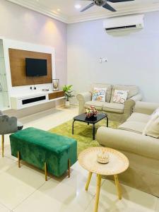 a living room with a couch and a tv at Kuantan Setali ROOMSTAY by Iconique in Kuantan