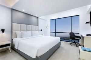 Postel nebo postele na pokoji v ubytování INNSiDE by Meliá Yogyakarta