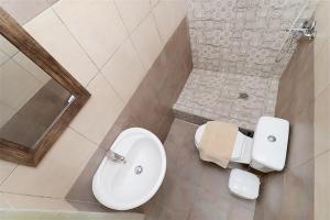 a bathroom with a toilet and a sink at Ioanna Beach House Fourka 2 bedrooms 5 guests in Skála Foúrkas
