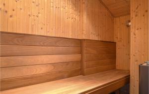 a sauna with wooden paneled walls and a bench at Holiday Home Arvidvej Hvide Sande Denm in Bjerregård +18 photos