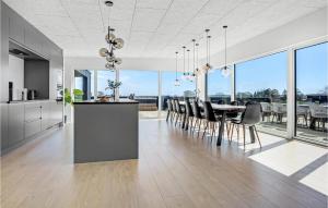 a kitchen and dining room with a table and chairs at Amazing Home In Børkop With Wifi in Børkop