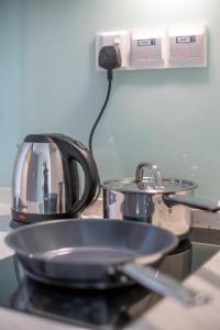 a toaster sitting on top of a counter with a pan at Riveria City near KL Sentral with 118 view Sky Infinity Pool by COBNB in Kuala Lumpur