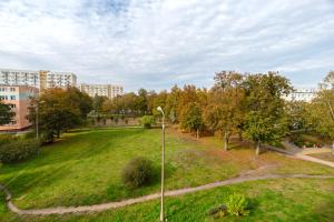 a park with a green field and a street light at Simple Nook, Gdańsk Wejhera by Real Apartments in Gdańsk