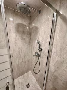 a shower with a shower head in a bathroom at Prime Stays at 34 Bratya Miladinovi Street in Sofia +20 photos