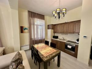 a small kitchen with a table and a couch at Prime Stays at 34 Bratya Miladinovi Street in Sofia