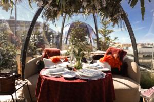 een tafel met een rood tafelkleed, glazen en een raam bij BLESS Hotel Madrid - The Leading Hotels of the World in Madrid