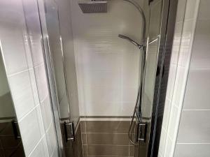 a shower with a glass door in a bathroom at Appartement 2 Pièces mezzanine 4 couchages ARGELES SUR MER AR210-015 in Argelès-sur-Mer