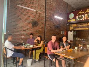 a group of people sitting at tables in a restaurant at Gia Hưng Khang Hometel in Ha Long +39 photos