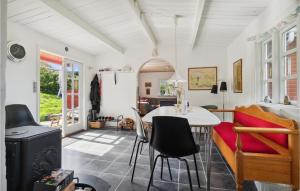 a living room with a table and chairs at 2 Bedroom Cozy Home In Allinge in Allinge