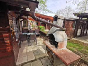 a patio with an outdoor oven in a house at Aqualuna Petrov brlog in Podčetrtek
