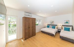 a bedroom with two beds and a window at Holiday Home Jadrija Vii Iii in Jadrija