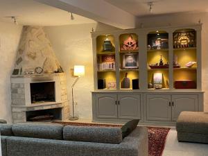 a living room with a couch and a fireplace at Maison Marmont in Vela Luka