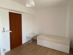 a bedroom with a bed and a wooden door at Casa Vacanza Iolanda in Mafalda +2 photos