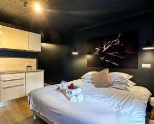 a bedroom with a large bed with a plate of food on it at Loveroom Adults Only jacuzzi vieille ville Annecy in Annecy