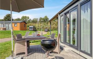 a grill on the patio of a house at Chalet 8 Am See in Süsel +19 photos