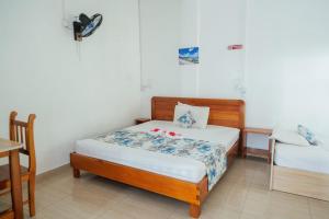a bedroom with a bed and a desk and a table at Coastal lodge in Port Mathurin